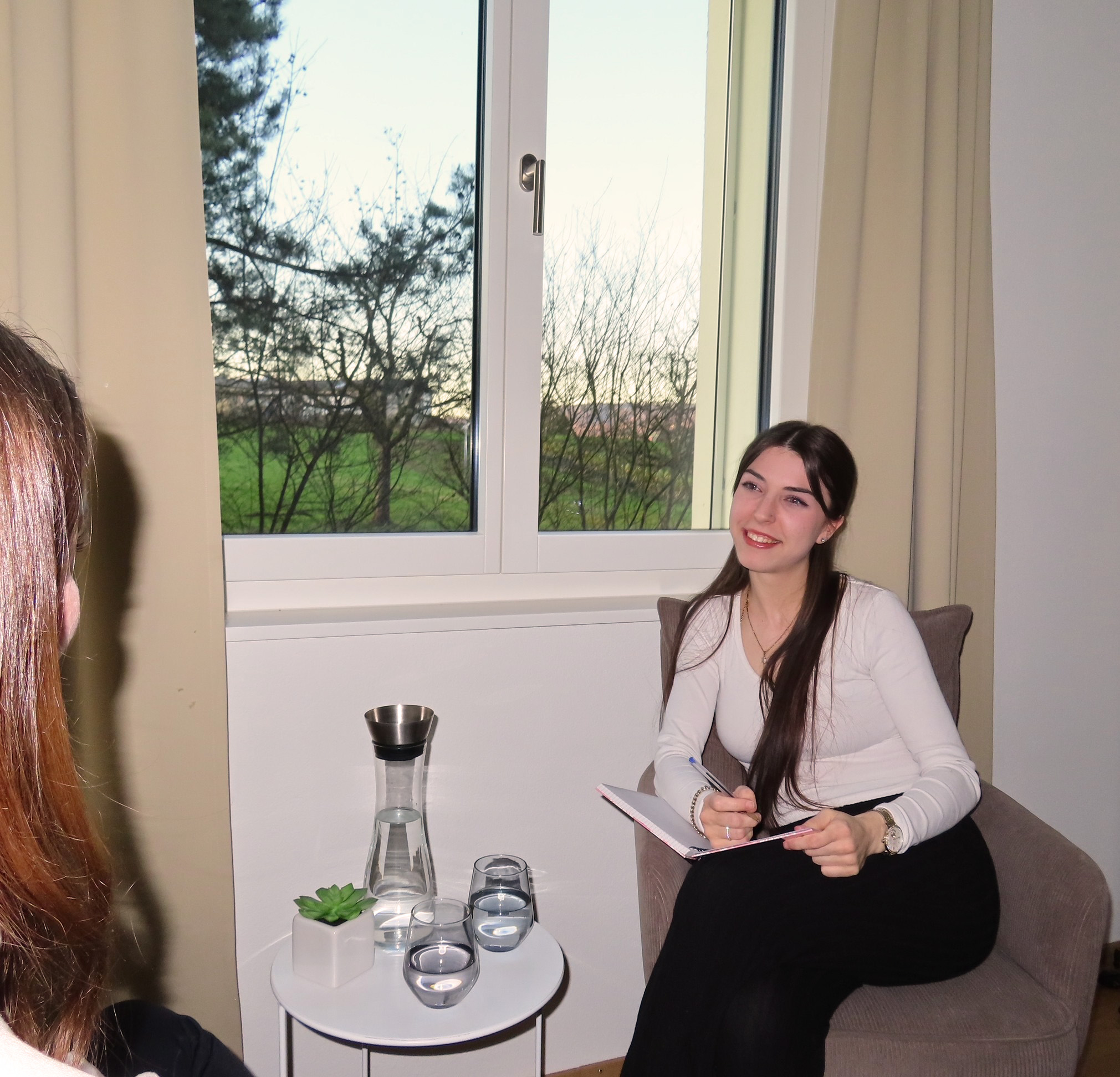 Three women smiling in yoga outfits